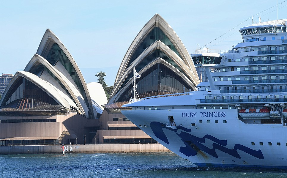 The Ruby Princess cruise ship docked beside the Sydney Opera House